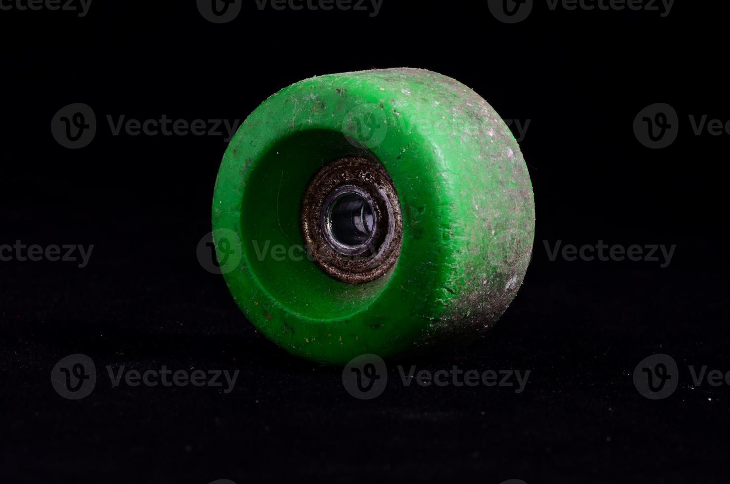 Skateboard wheel on black background photo