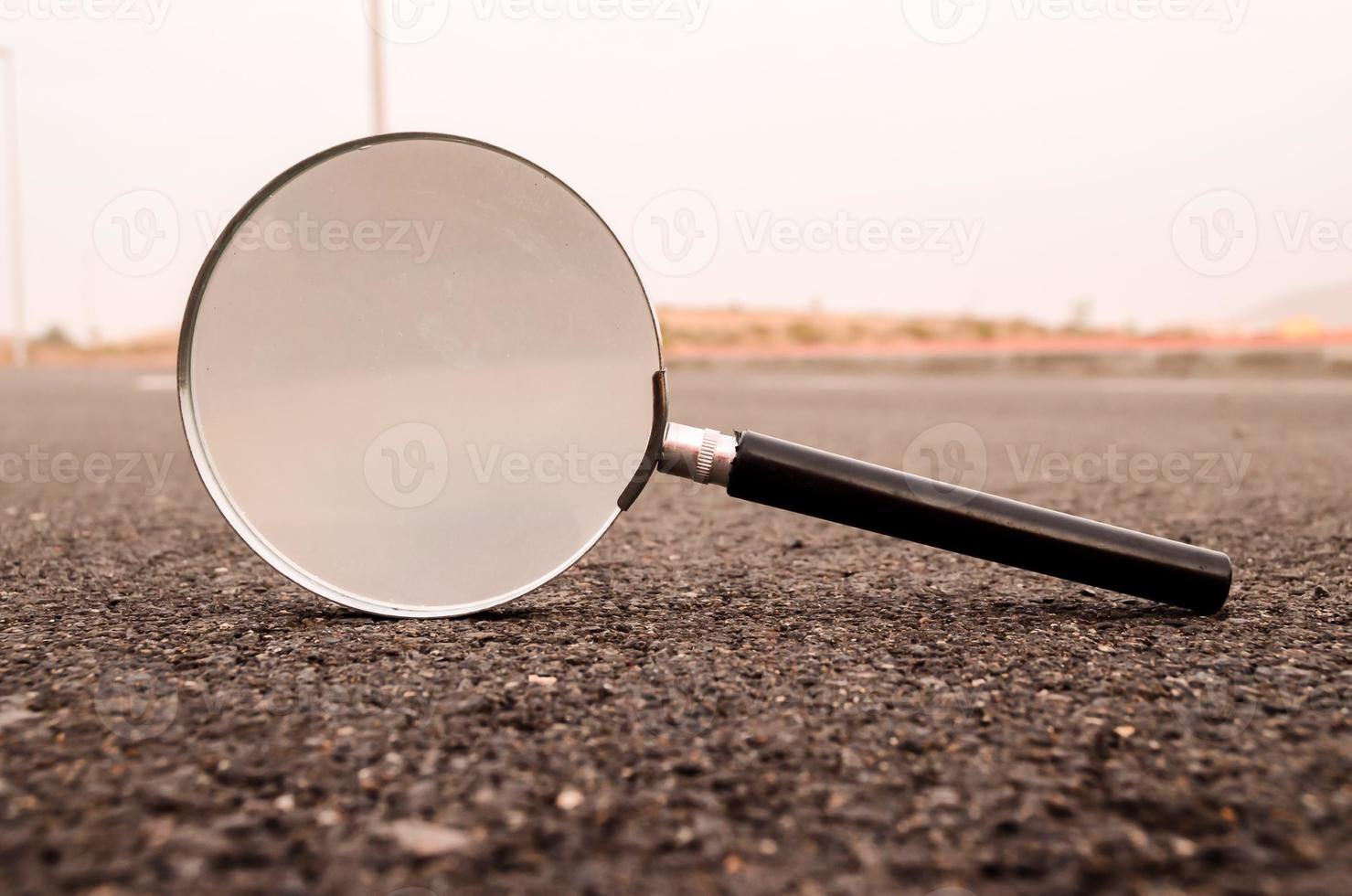 Magnifying glass on the ground photo