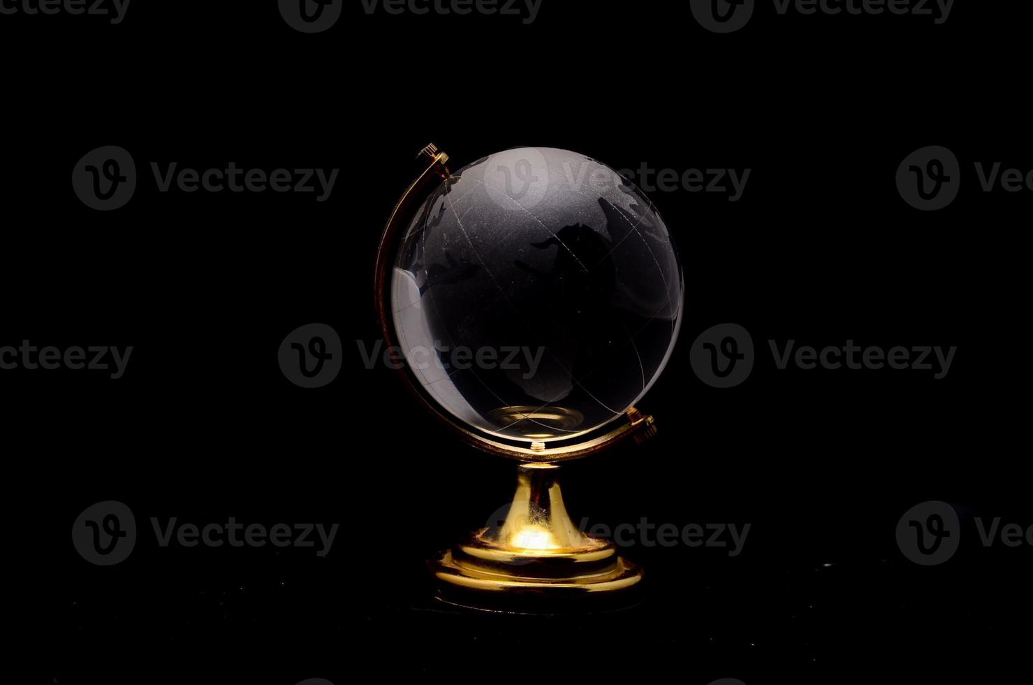 Glass globe on black background photo