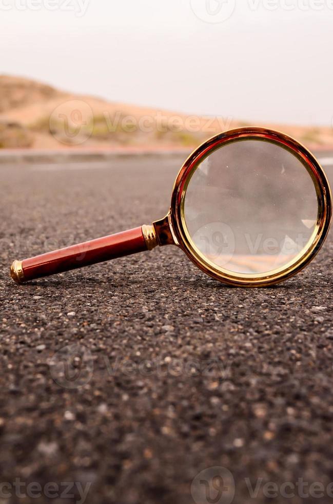 Magnifying glass on the road photo