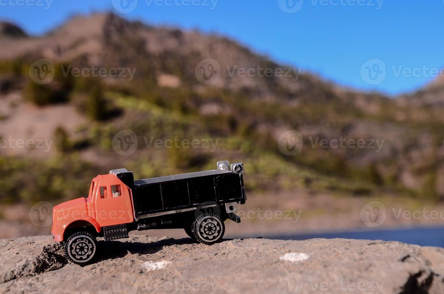 Toy truck on a rock photo