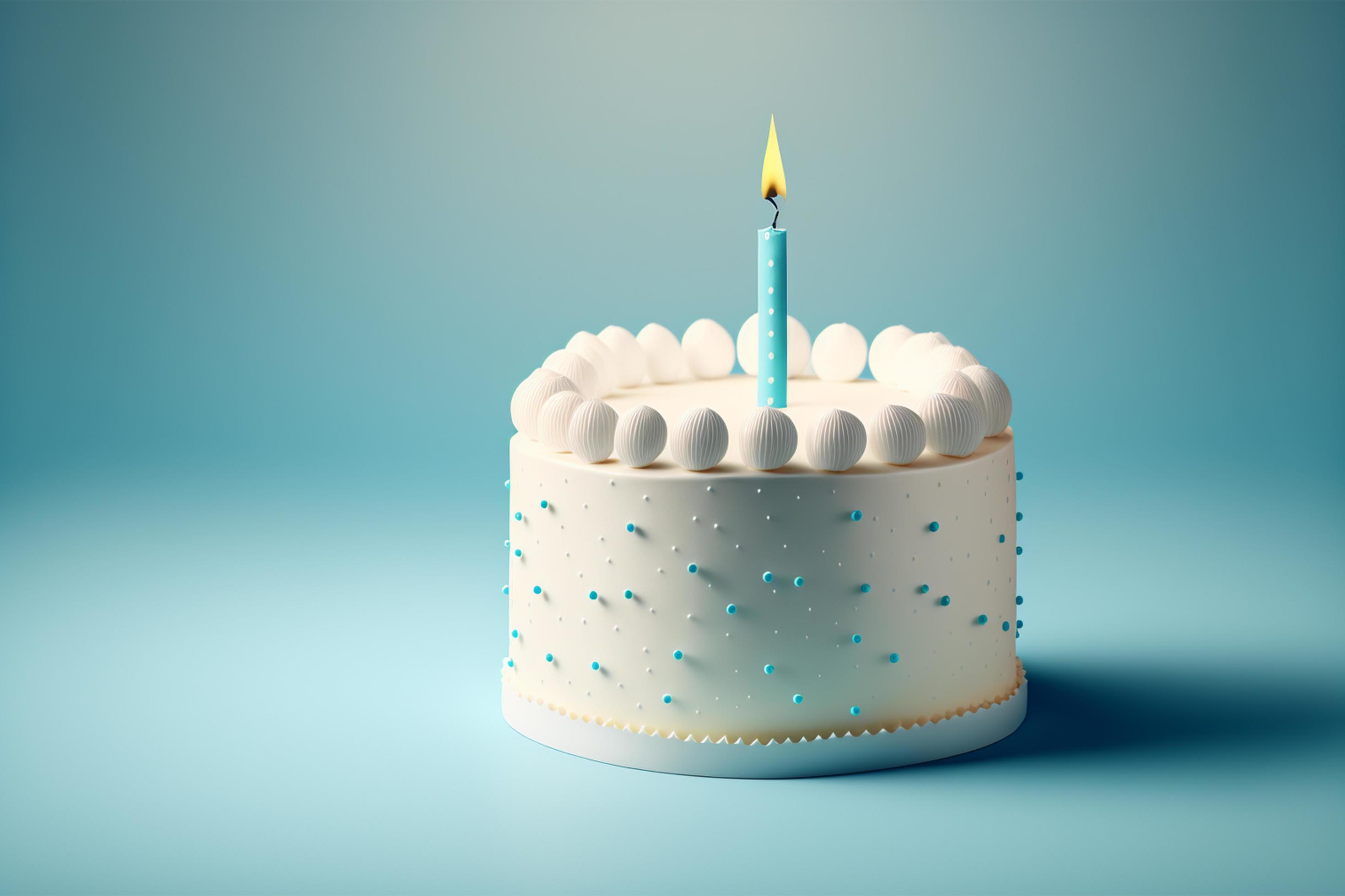 White birthday cake with candles over blue background, blank empty