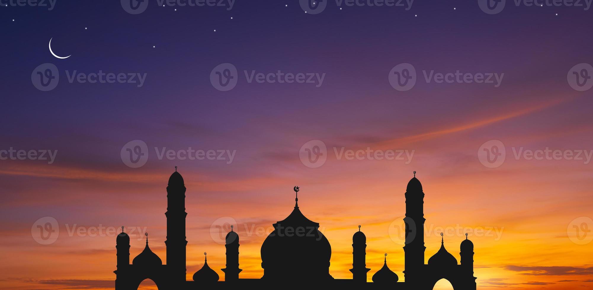 Panoramic view of silhouette mosque dome against colorful dusk sky and crescent moon with stars in the evening twilight, background design for iftar period during Ramadan Holy month photo