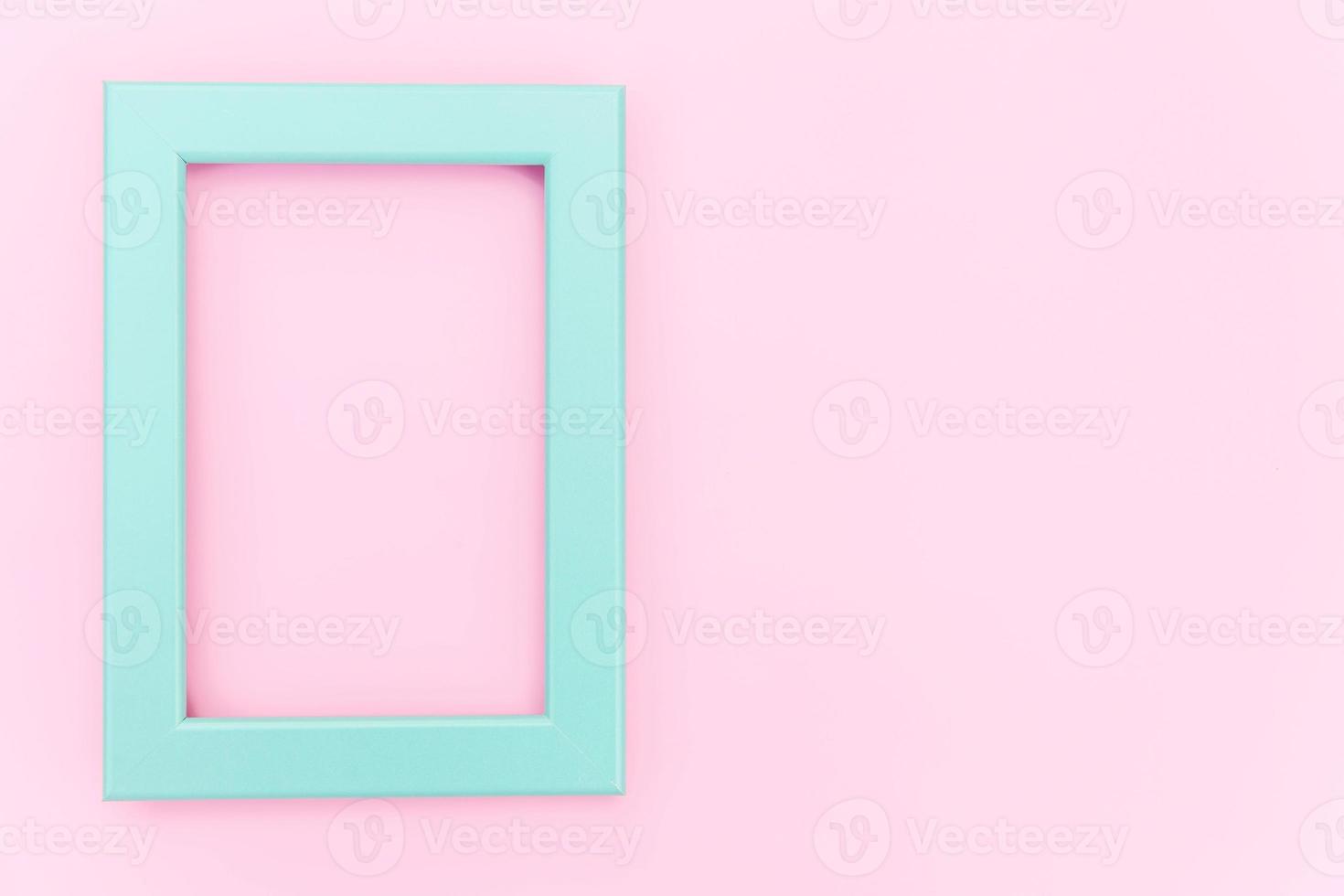 Simply design with empty blue frame isolated on pink pastel colorful background. Top view, flat lay, copy space, mock up. Minimal concept. photo