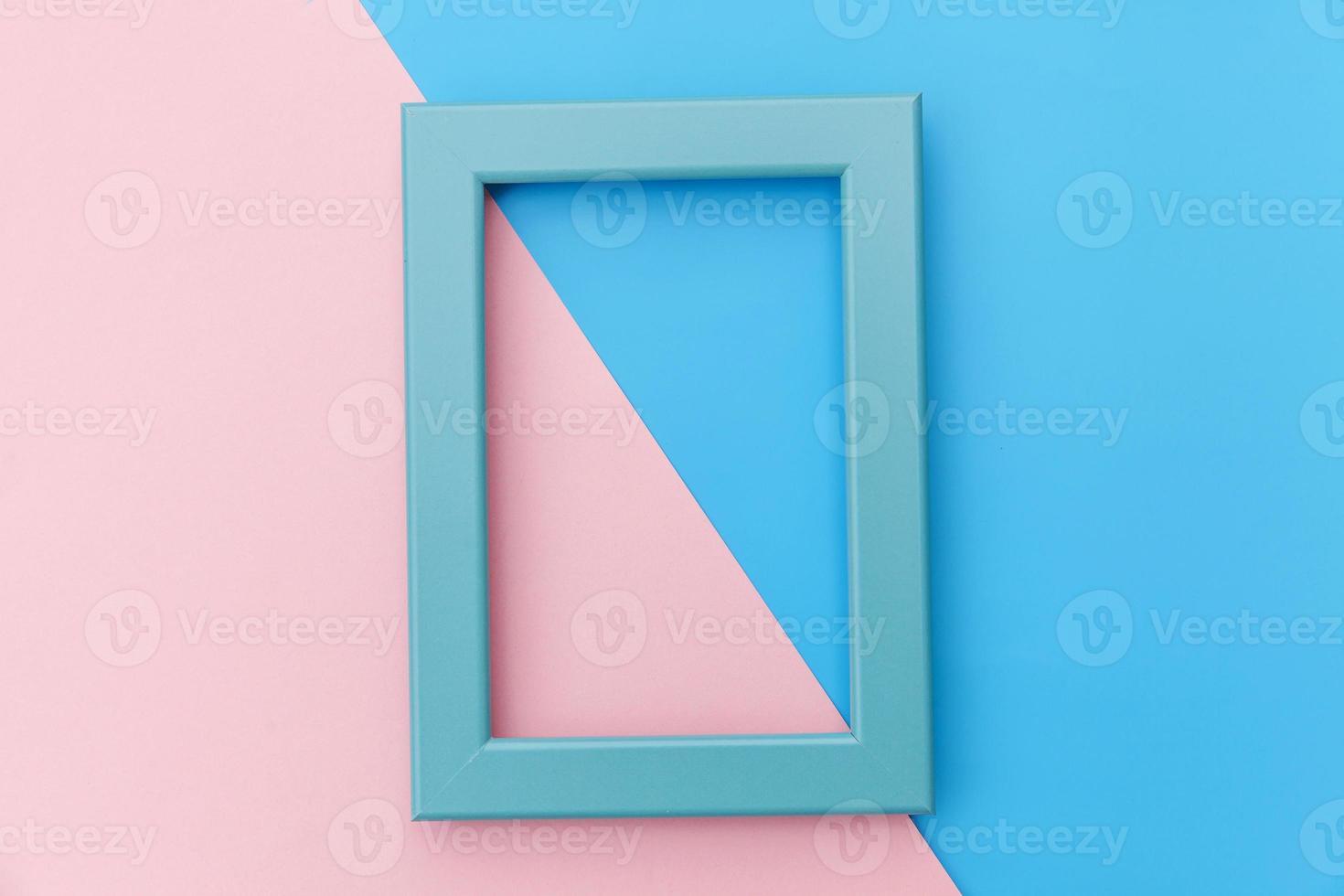 Simply design with empty blue frame isolated on pink and blue pastel colorful background. Top view, flat lay, copy space, mock up. Minimal concept. photo