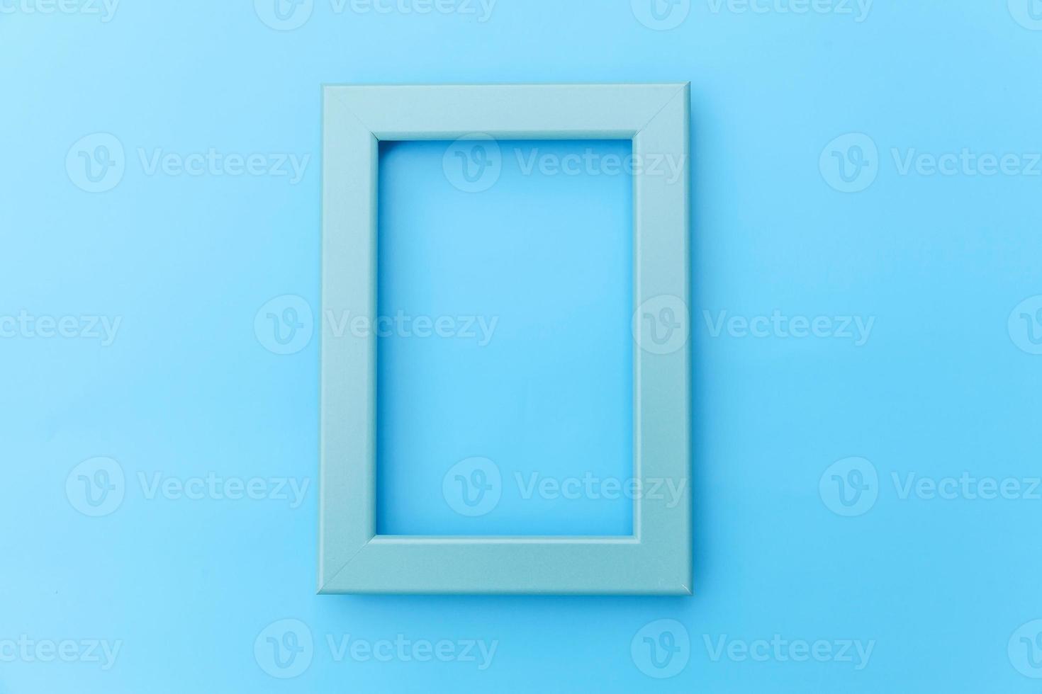 Simply design with empty blue frame isolated on blue pastel colorful background. Top view, flat lay, copy space, mock up. Minimal concept. photo