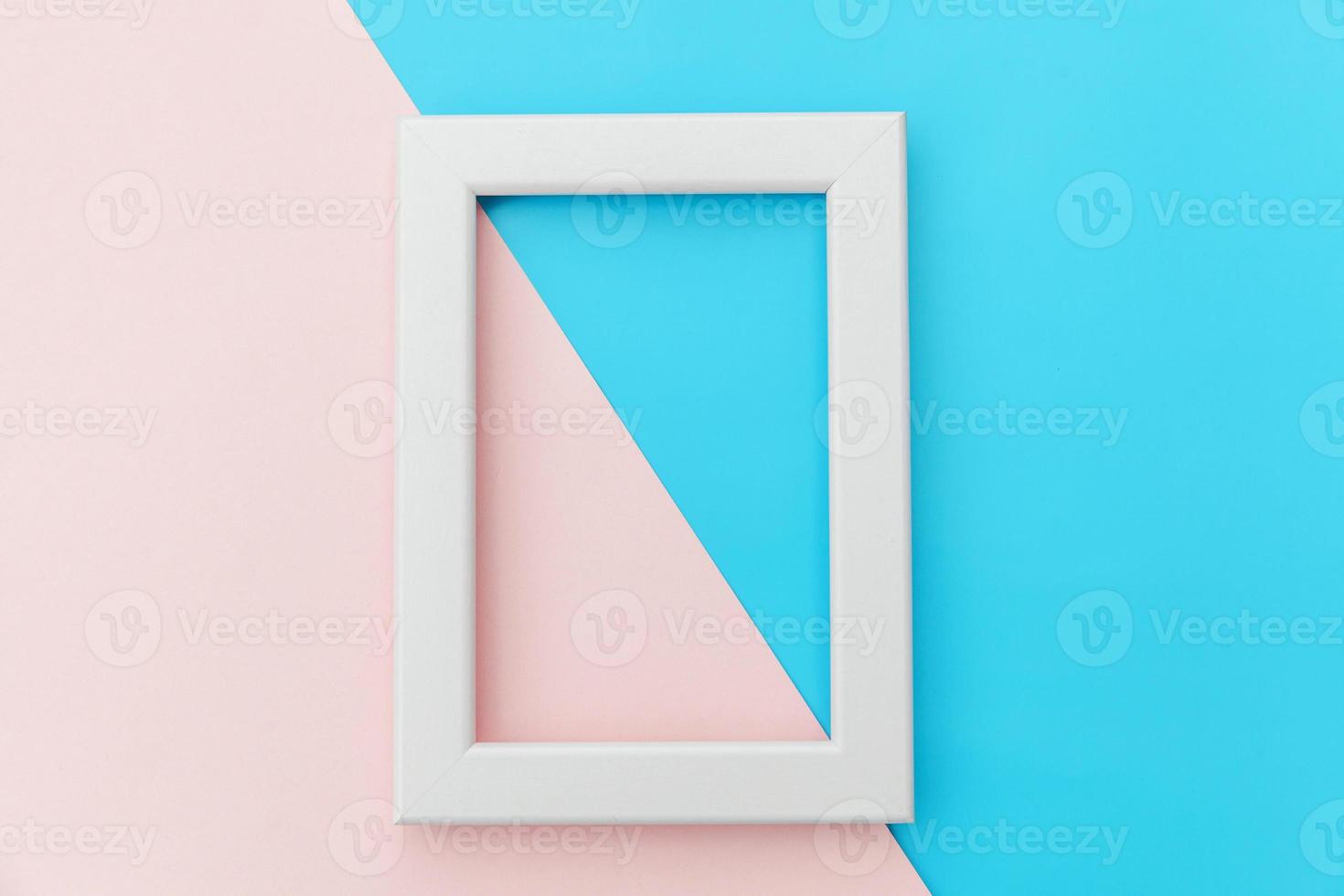 Simply design with empty pink frame isolated on pink and blue pastel colorful background. Top view, flat lay, copy space, mock up. Minimal concept. photo