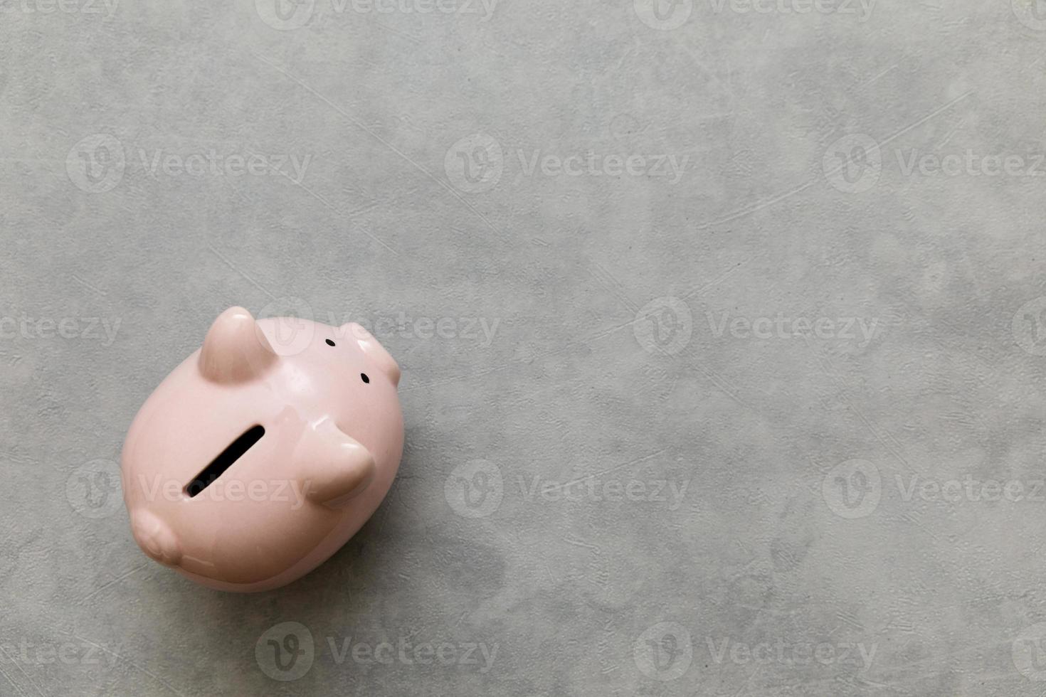 Simply minimal design piggy bank on concrete stone grey background. Saving investment budget wealth business retirement financial money banking concept. Flat lay top view copy space banner. photo