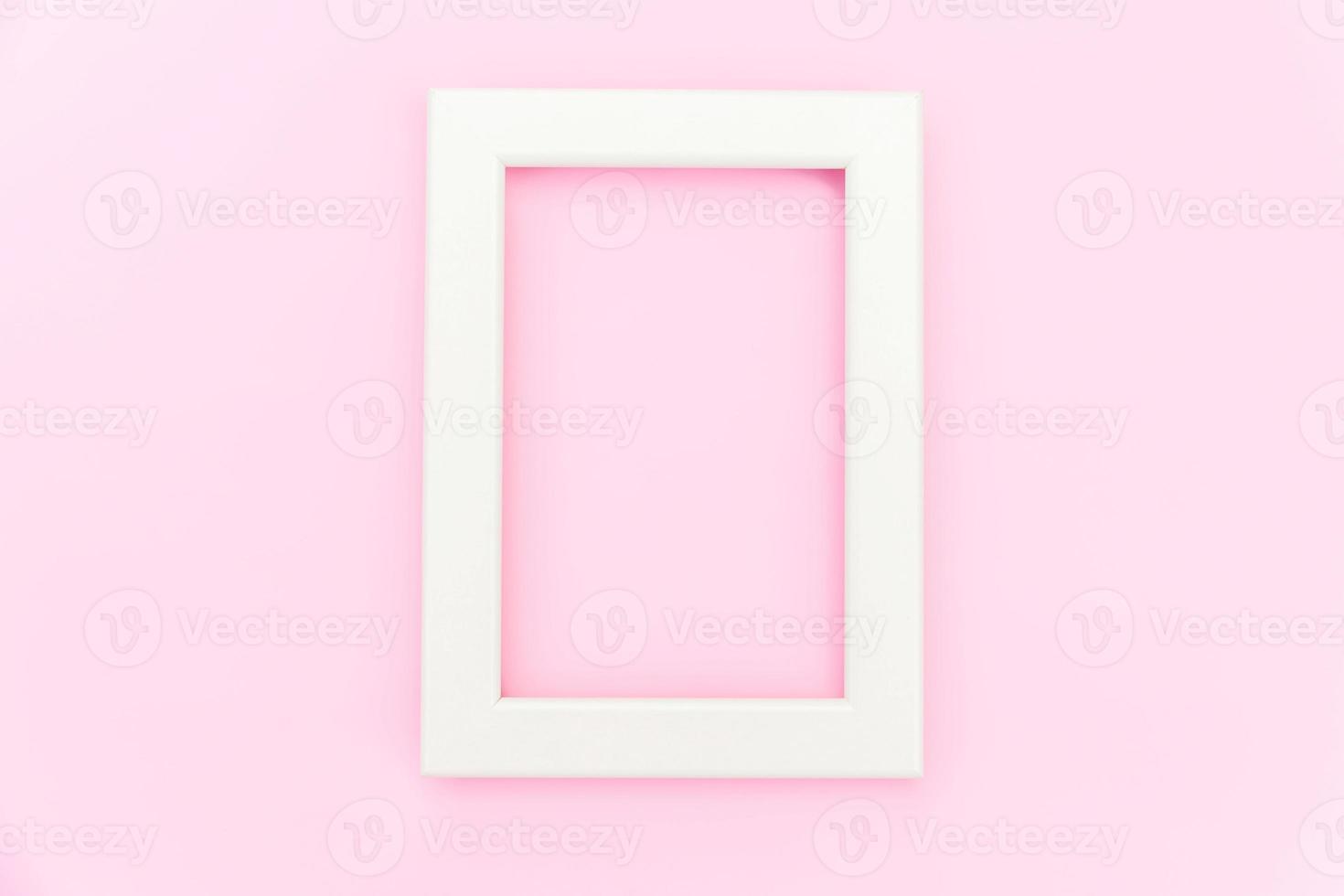 Simply design with empty pink frame isolated on pink pastel colorful background. Top view, flat lay, copy space, mock up. Minimal concept. photo