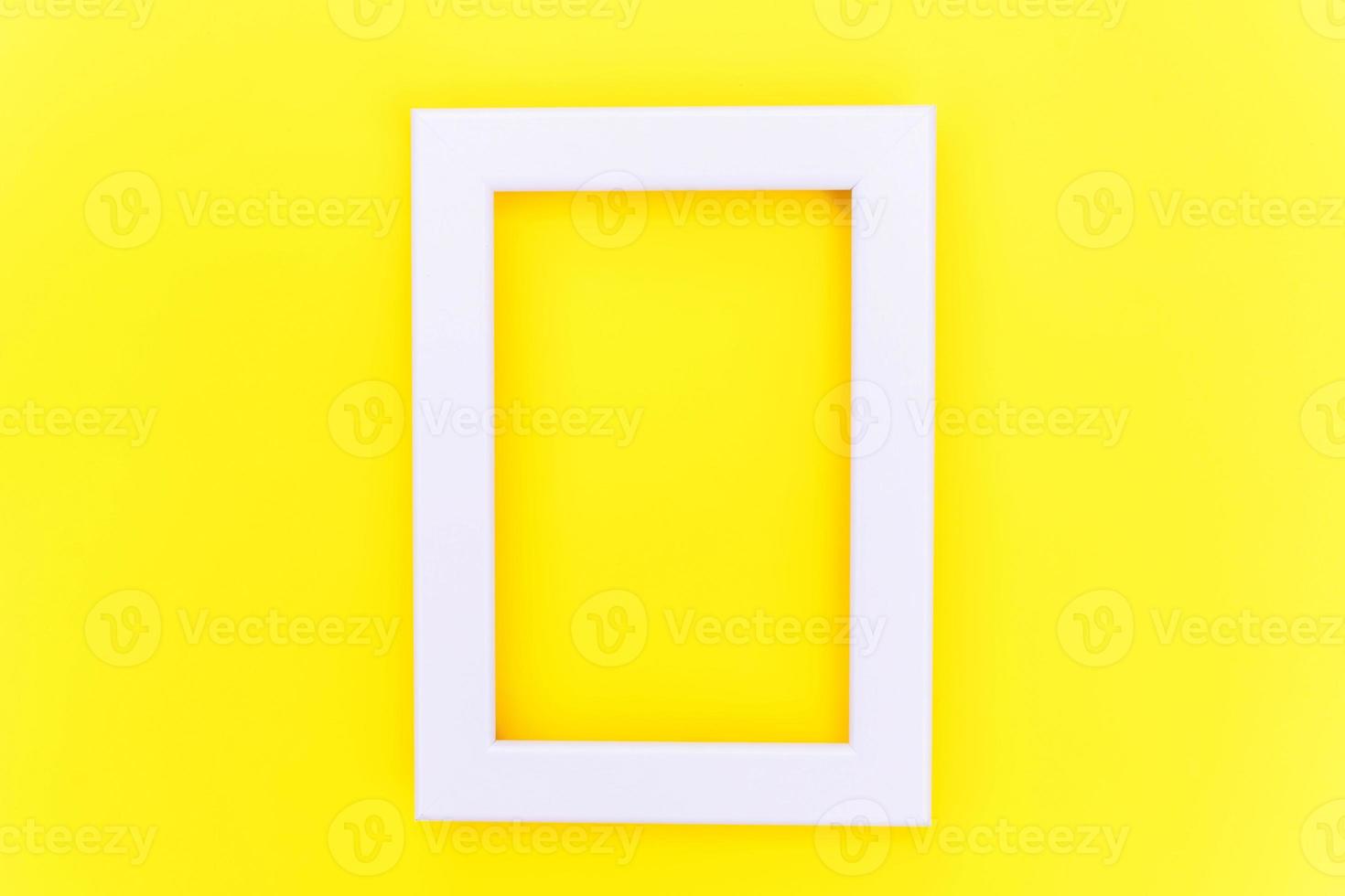 Simply design with empty pink frame isolated on yellow colourful trendy background. Top view, flat lay, copy space, mock up. Minimal concept. photo