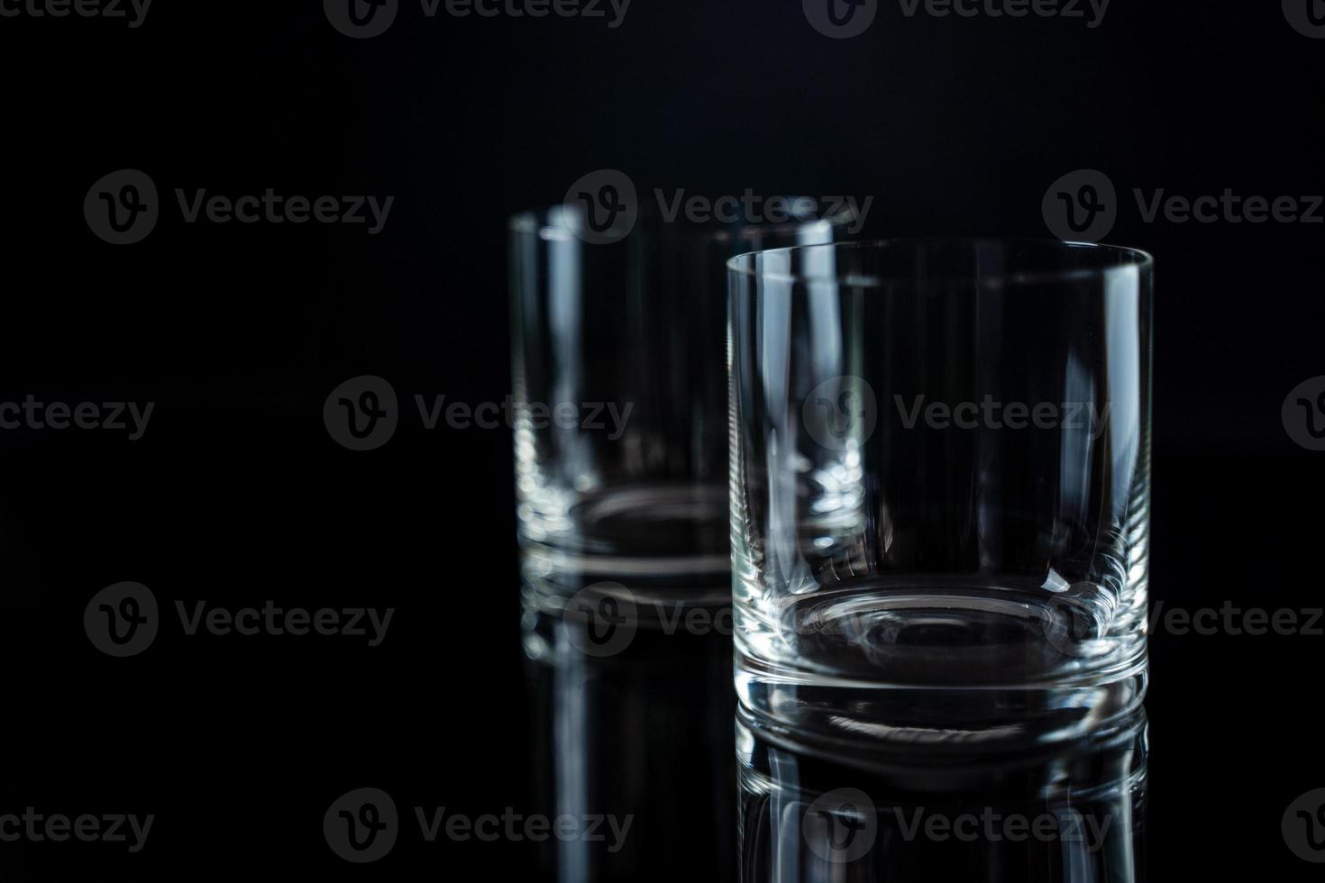 Elegant simple glass of luxury whisky against black background. Shiny Whiskey glass isolated background, studio shot. Copyspace. Strong alcohol beverage. photo