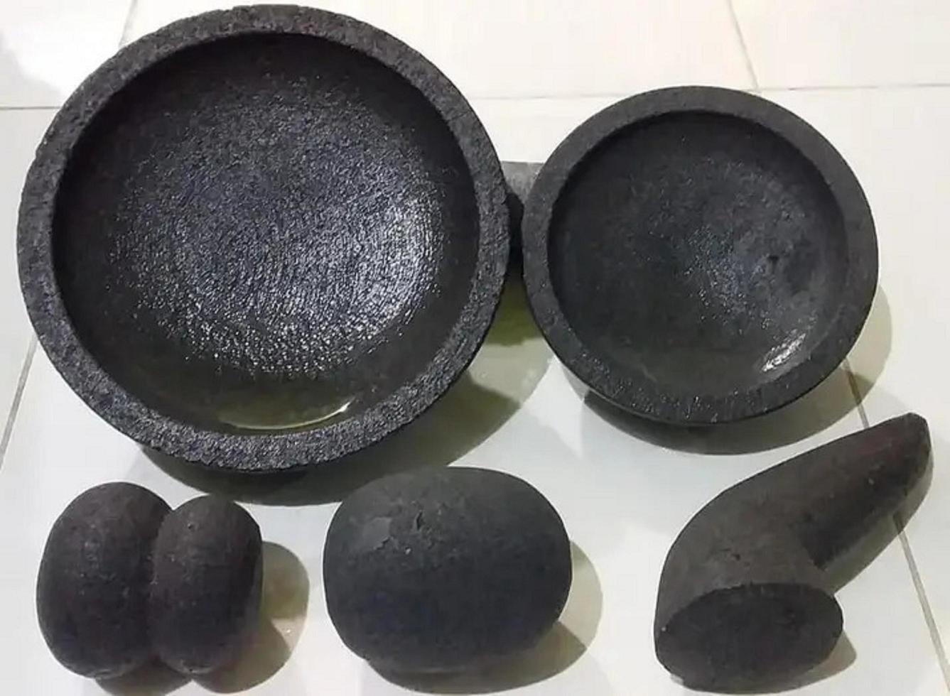Stone Mortar and Pestle isolated on white background with clipping path.Stone mortar is an important tool in making chili curry in Thai food. photo