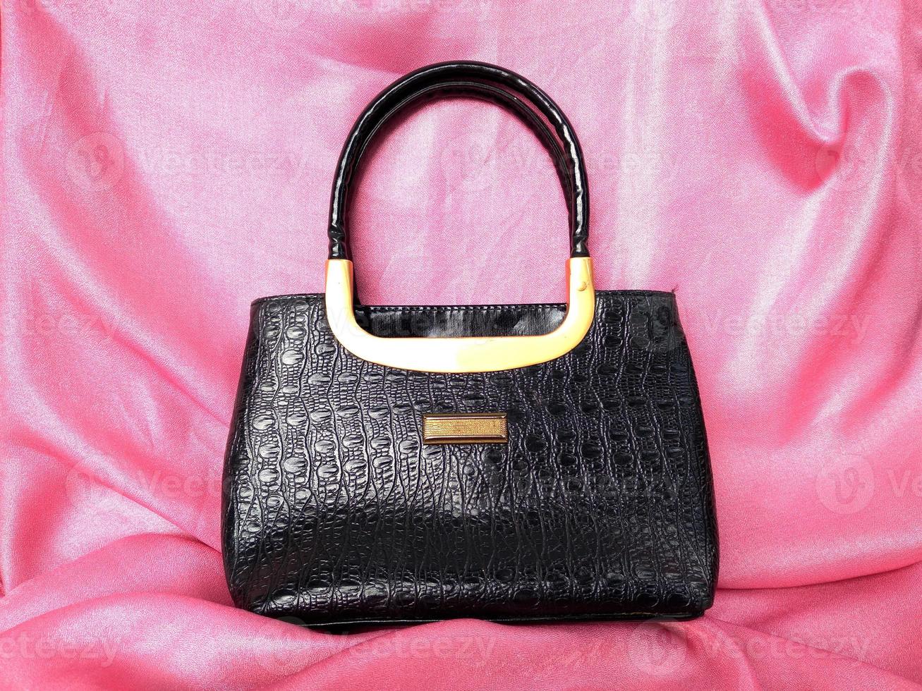 The black crocodile skin bag looks elegant and luxurious but still simple, perfect for going to parties or invitations photo