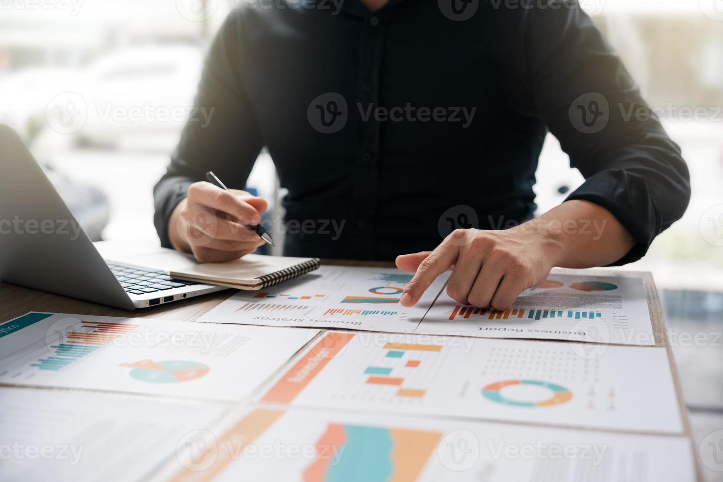 Businessman analyzing company's financial balance sheet working with digital augmented reality graphics. Businessman calculates financial data for long-term investment. photo