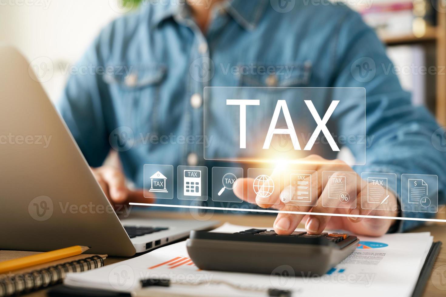 Corporate and individual tax payment concept, businessman using computer filling out corporate and personal income tax return, VAT and property tax of business. photo
