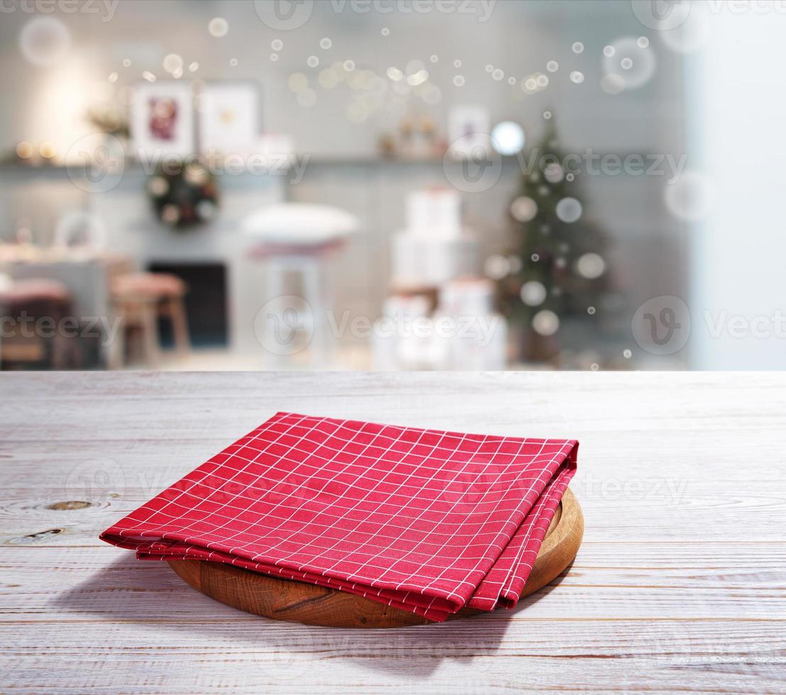 Red napkin with pizza board on wooden table and Christmas background. photo