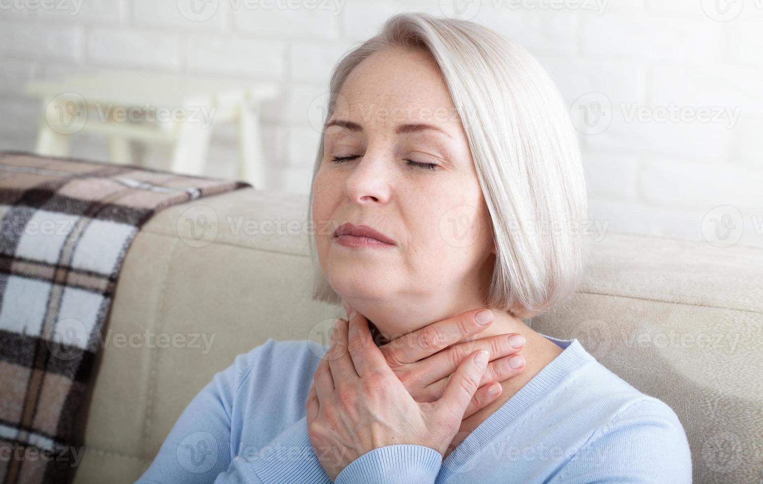 Concept coronavirus, covid-19 respiratory virus with indicating location of the pain.Woman suffering from stress or a headache grimacing in pain as she holds the back of her neck photo