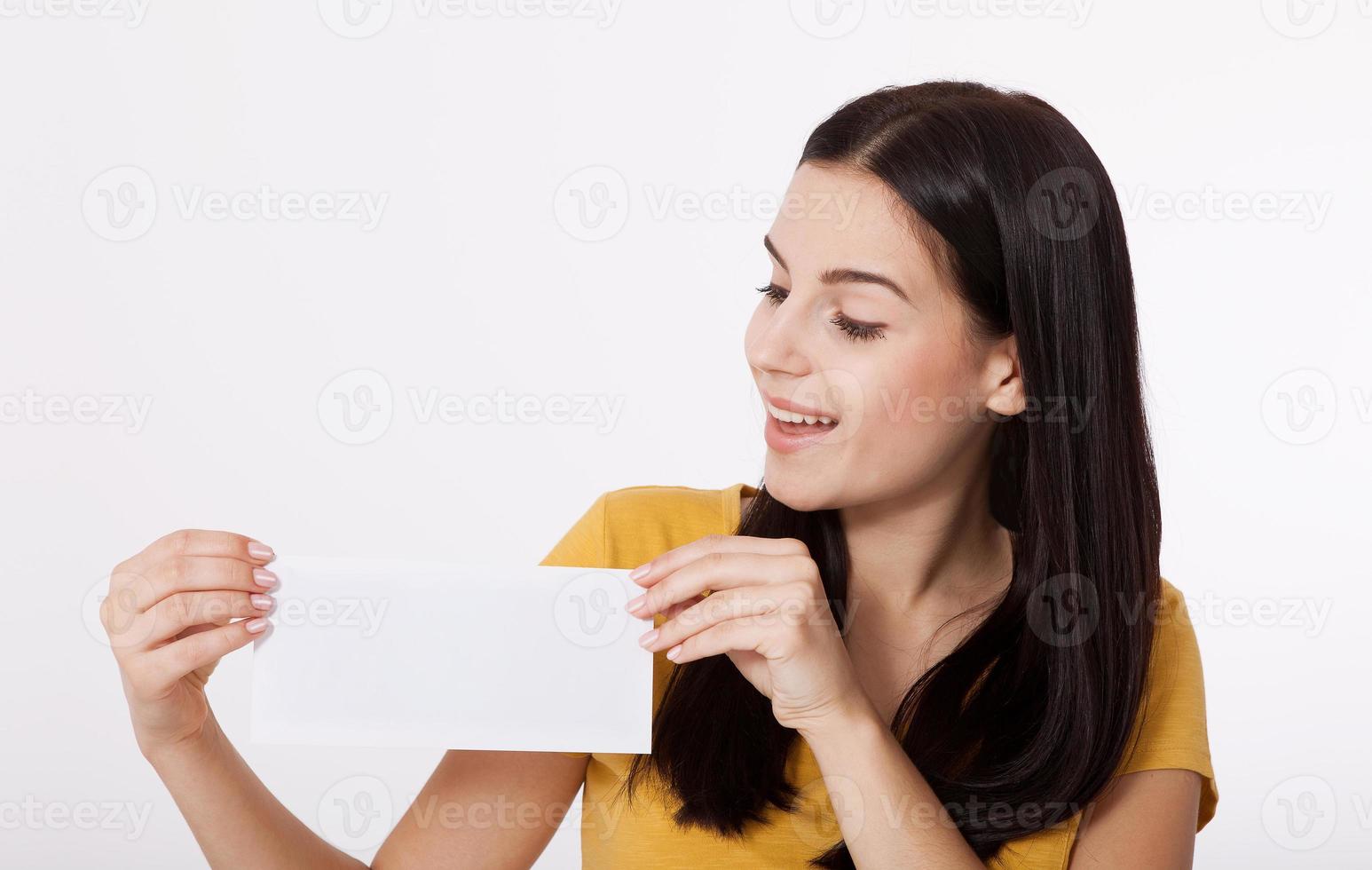Your text here. Pretty young woman holding empty blank board. Studio portrait on white background. Mock up for design photo