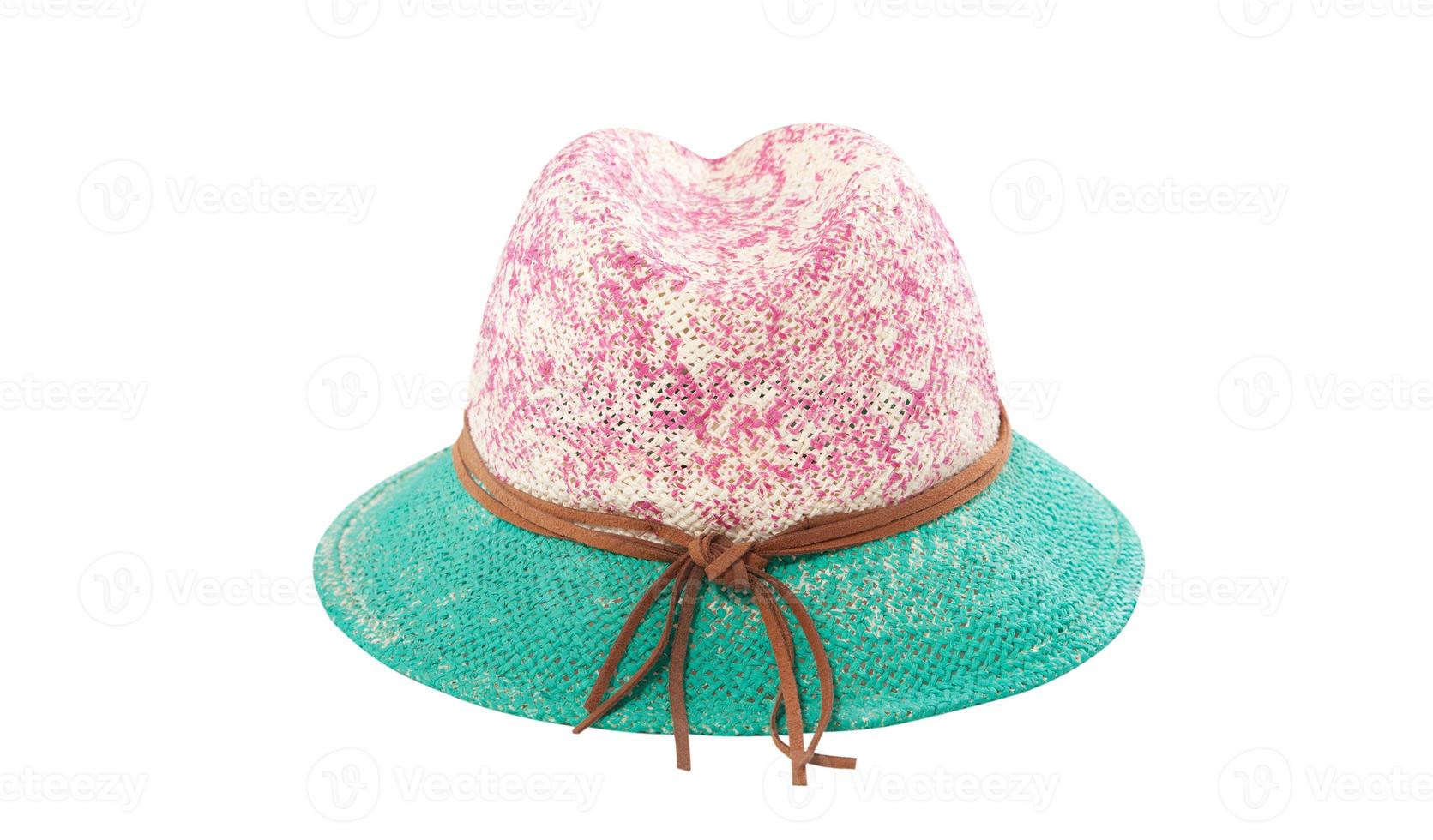 Pretty straw hat with ribbon and bow on white background. Beach hat top view isolated photo