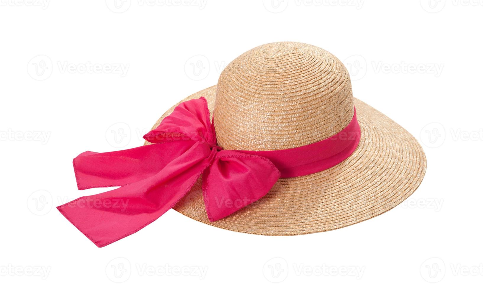 Pretty straw hat with ribbon and bow on white background. Beach hat top view isolated photo