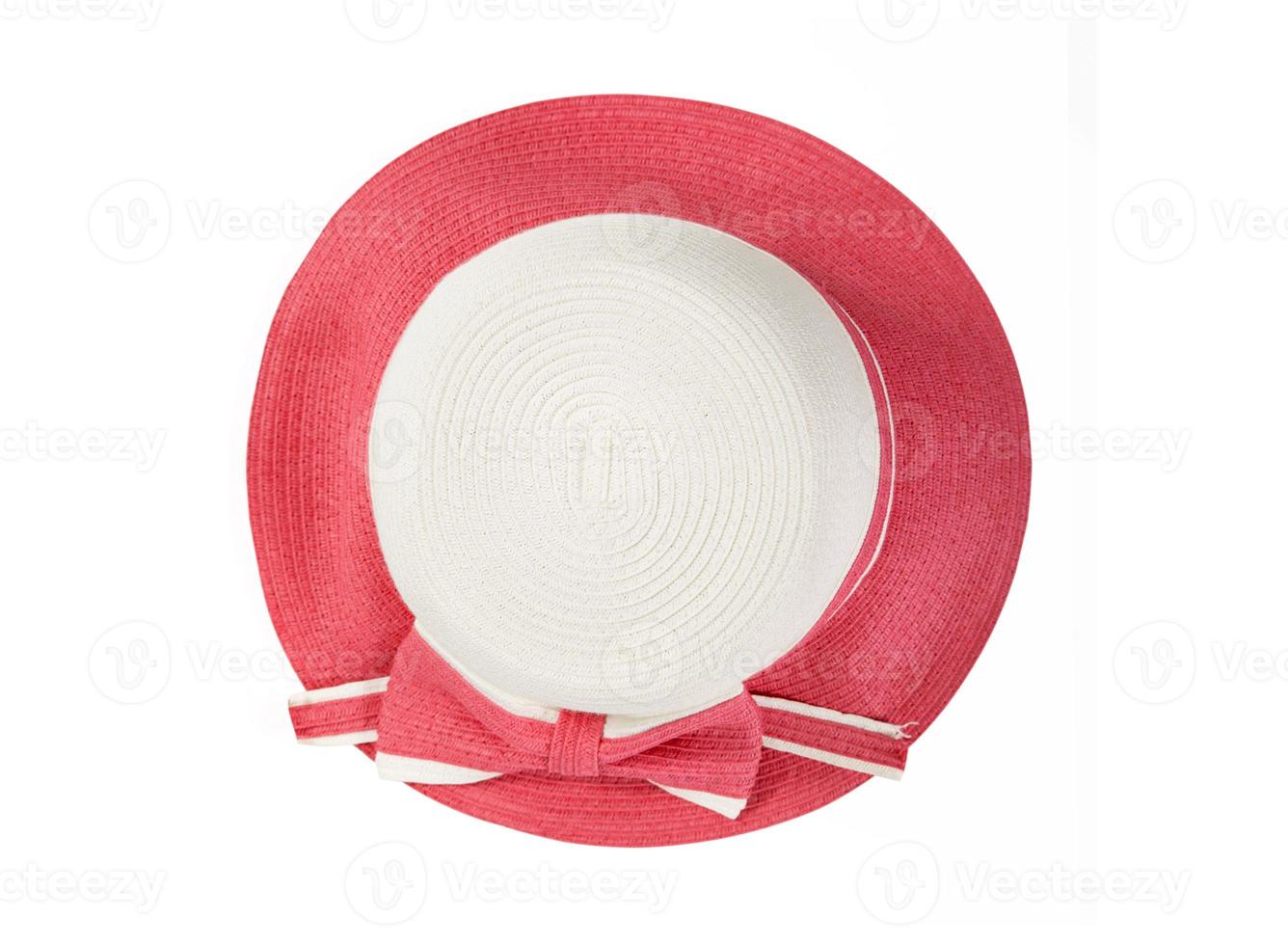 Pretty straw hat with ribbon and bow on white background. Beach hat top view isolated photo