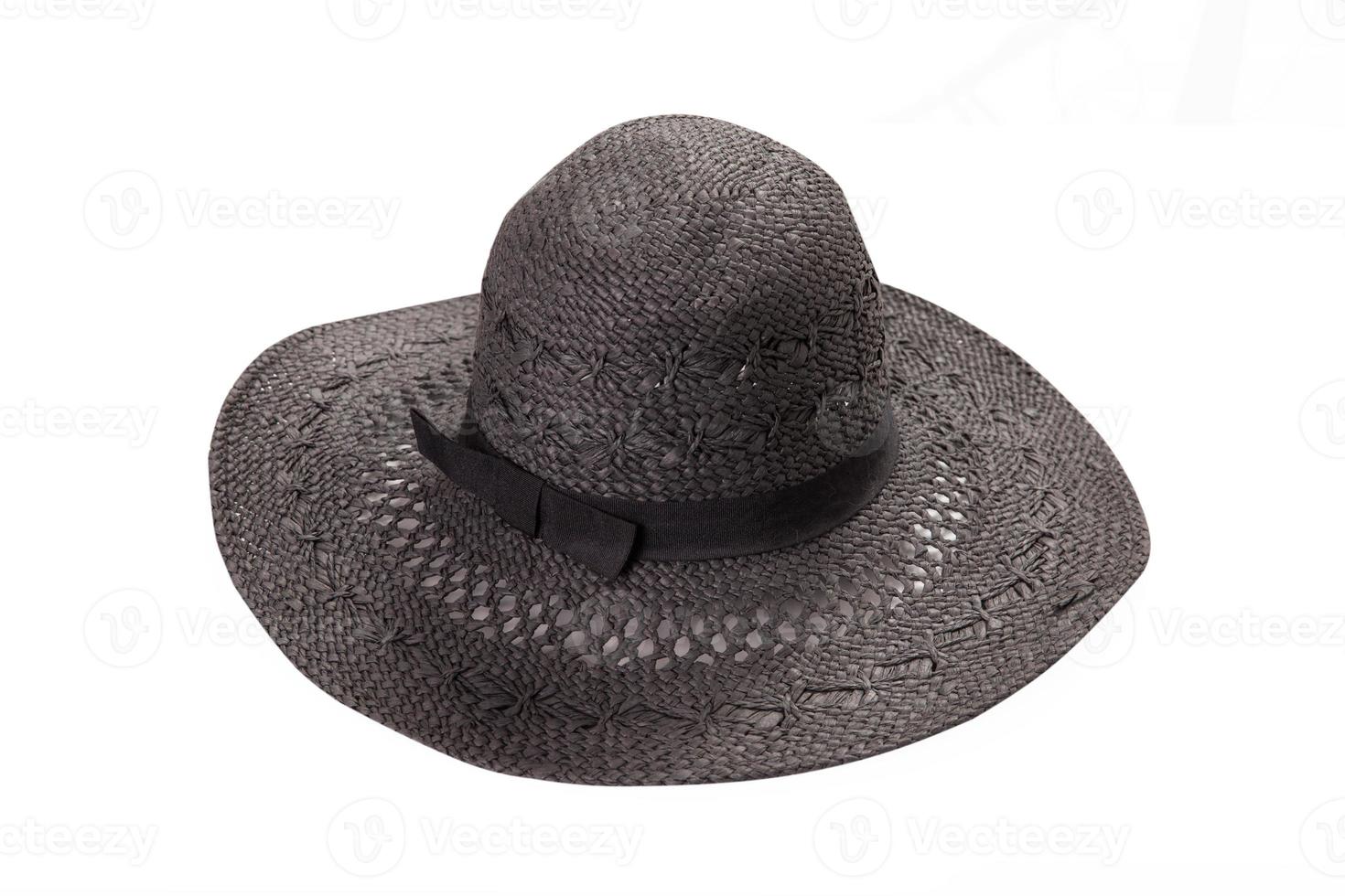 Pretty straw hat with ribbon and bow on white background. Beach hat top view isolated photo