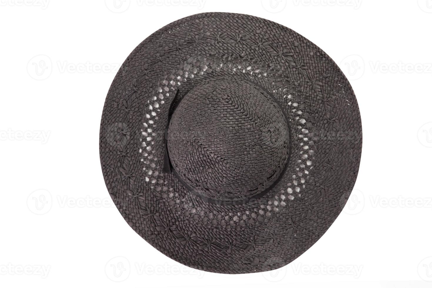 Pretty straw hat with ribbon and bow on white background. Beach hat top view isolated photo