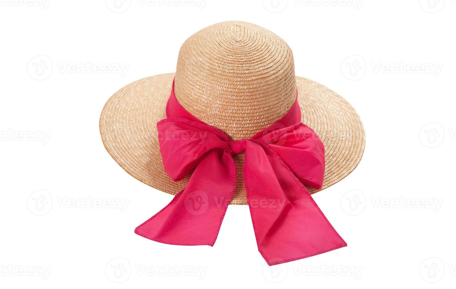 Pretty straw hat with ribbon and bow on white background. Beach hat top view isolated photo