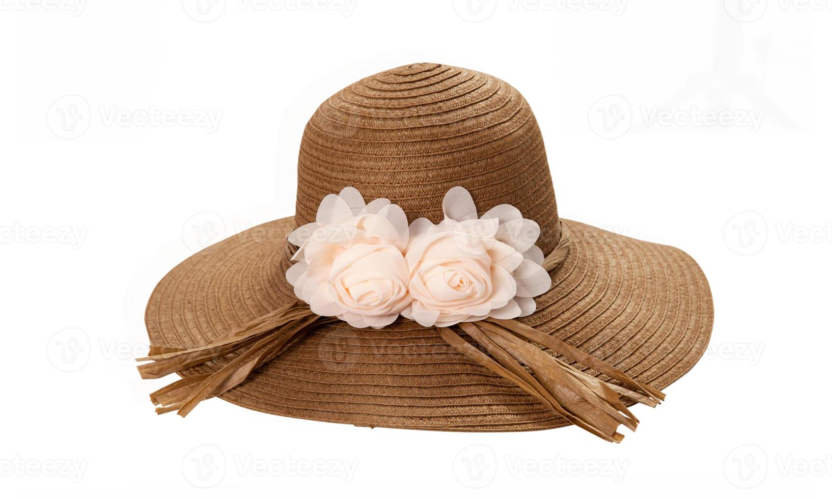 Pretty straw hat with ribbon and bow on white background. Beach hat top view isolated photo