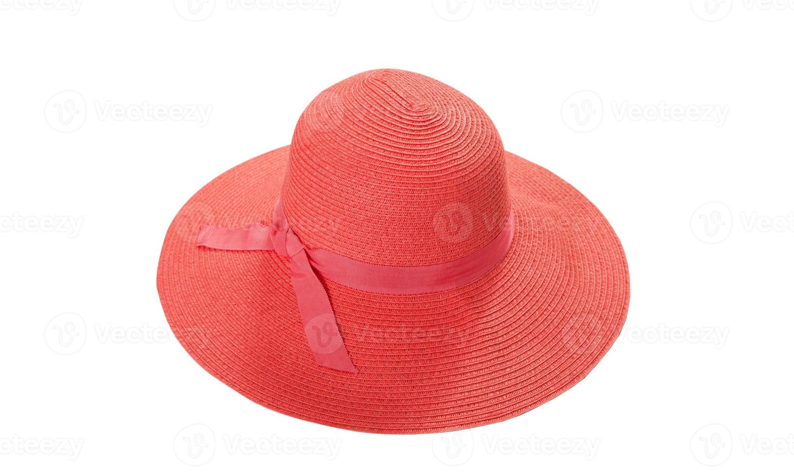 Pretty straw hat with ribbon and bow on white background. Beach hat top view isolated photo