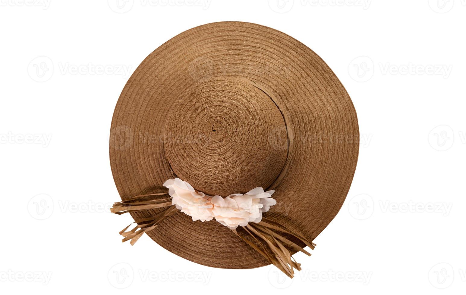 Pretty straw hat with ribbon and bow on white background. Beach hat top view isolated photo