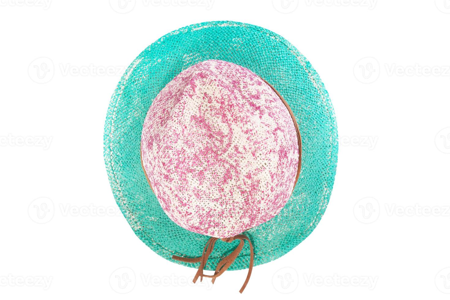Pretty straw hat with ribbon and bow on white background. Beach hat top view isolated photo