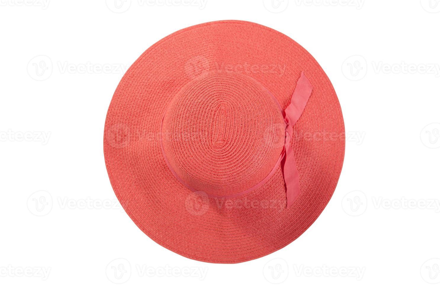 Pretty straw hat with ribbon and bow on white background. Beach hat top view isolated photo