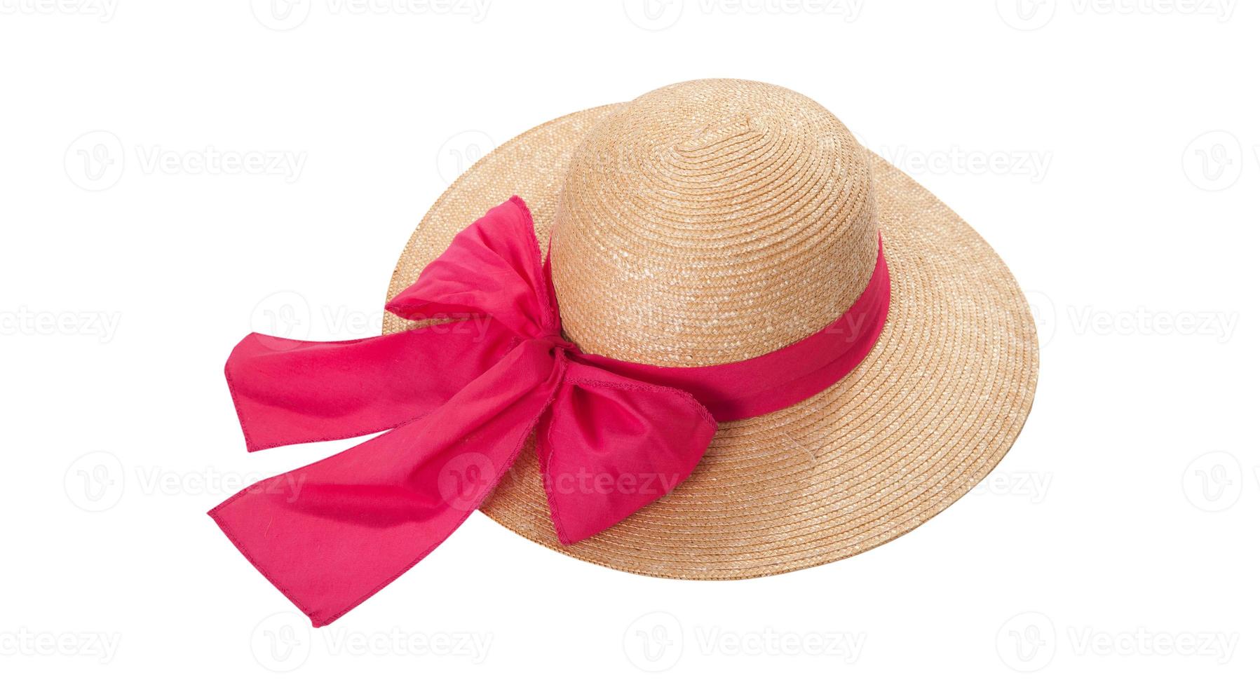 Pretty straw hat with ribbon and bow on white background. Beach hat top view isolated photo