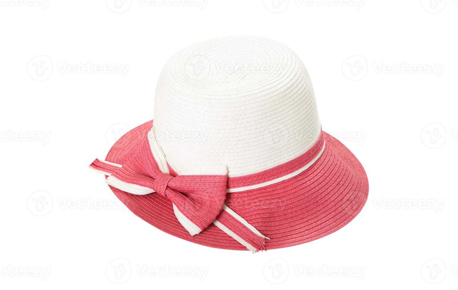 Pretty straw hat with ribbon and bow on white background. Beach hat top view isolated photo