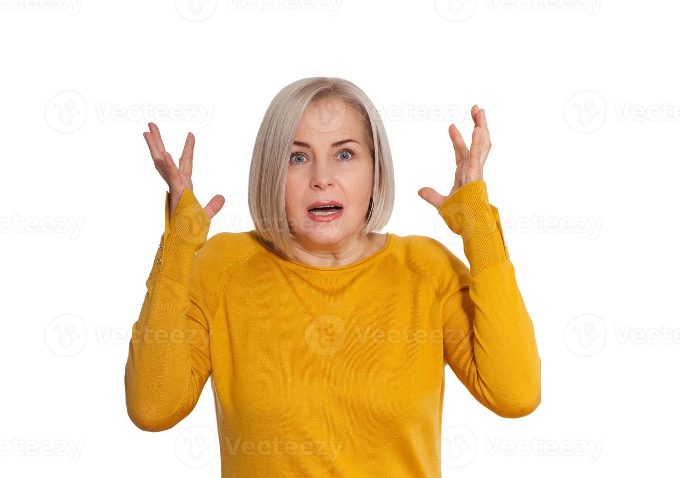 Attractive Middle Aged Woman expresses fear and horror, panic and cry, hysterics and problem, surprise and fright. Woman in bright clothes posing in studio on white background photo