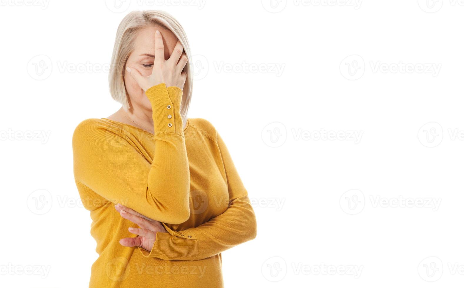 Curious woman covering face with hands peeping spying eye on white studio wall, funny woman feeling afraid fear shy hiding looking at camera through fingers isolated on white blank background photo