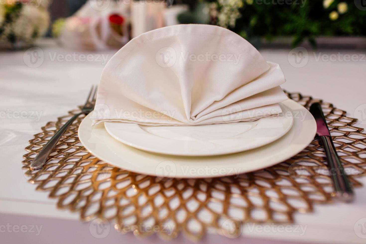 Elegant and chic gold and white table setting. selective focus photo