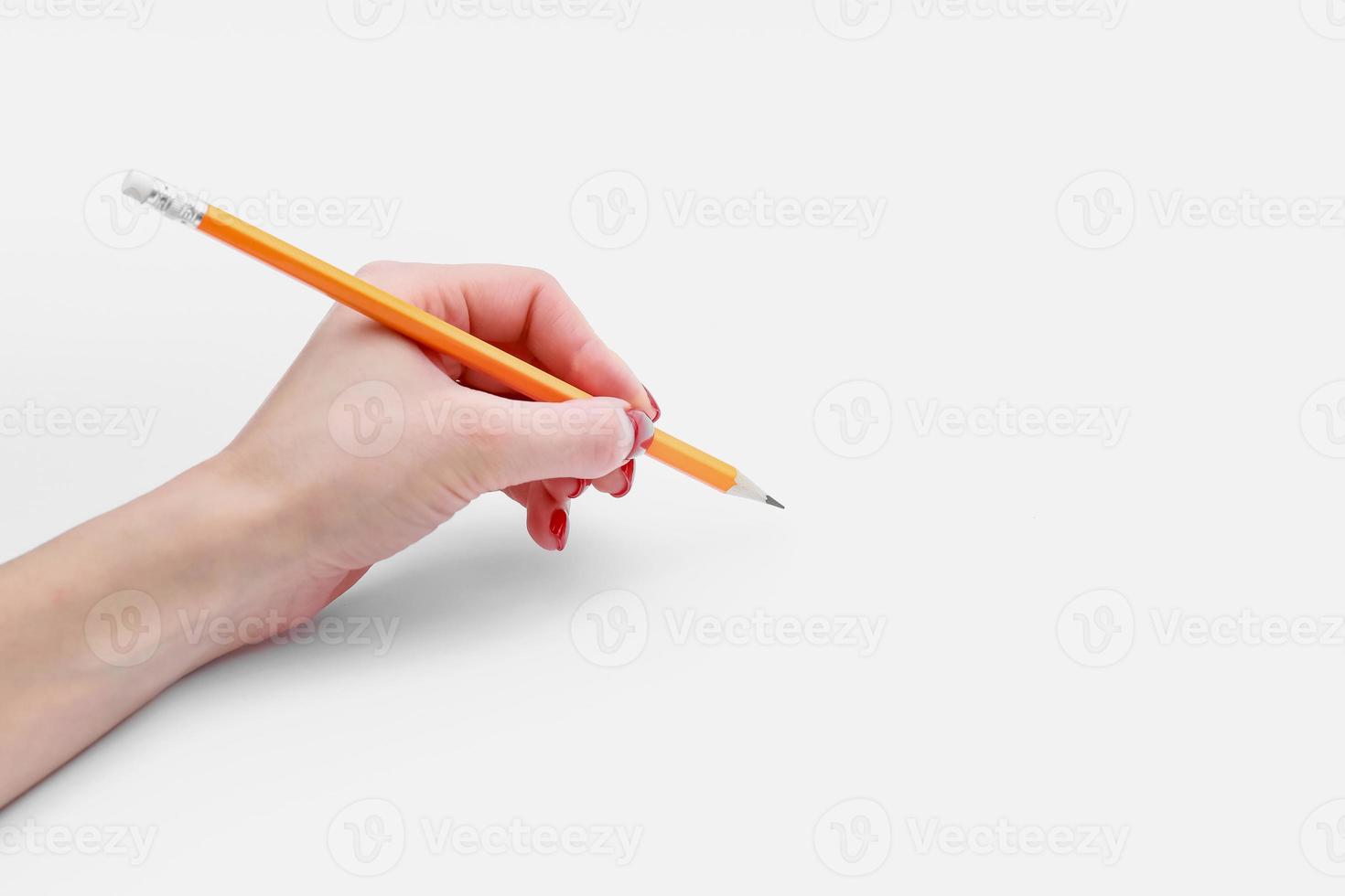 Female hand holding pencil isolated on white background, close-up, cutout, copy space photo