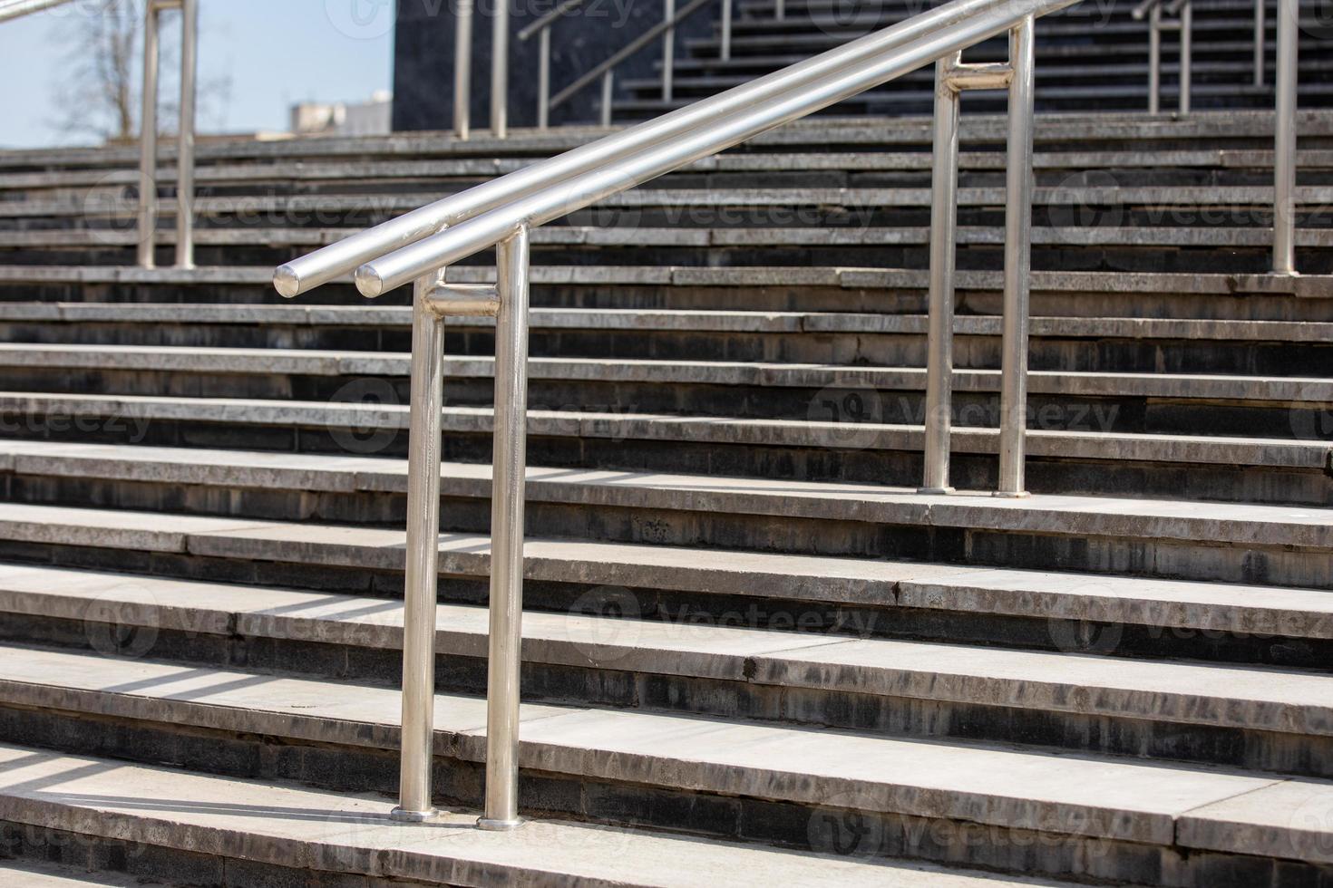 Outdoor Concrete Staircase With Stainless Steel Handrail, Front View, Close Up photo
