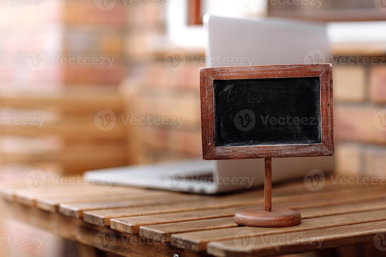 Empty wooden plate on wooden table in a restaurant, copy space for example reserved. High quality photo