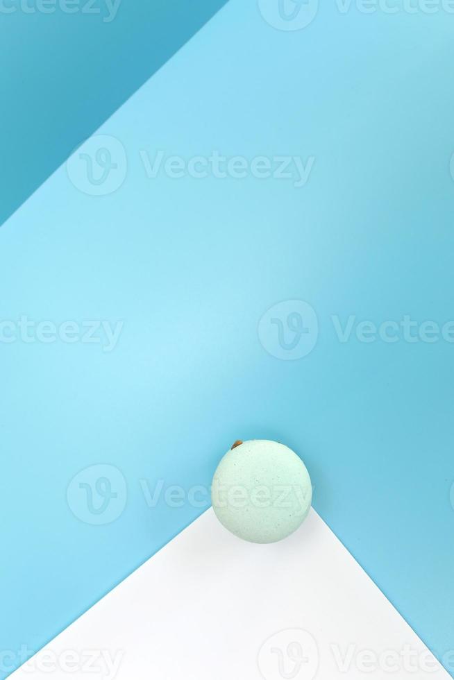 Tasty blue french macaron or macaroon on a white and blue background. Place for text. color geometry photo