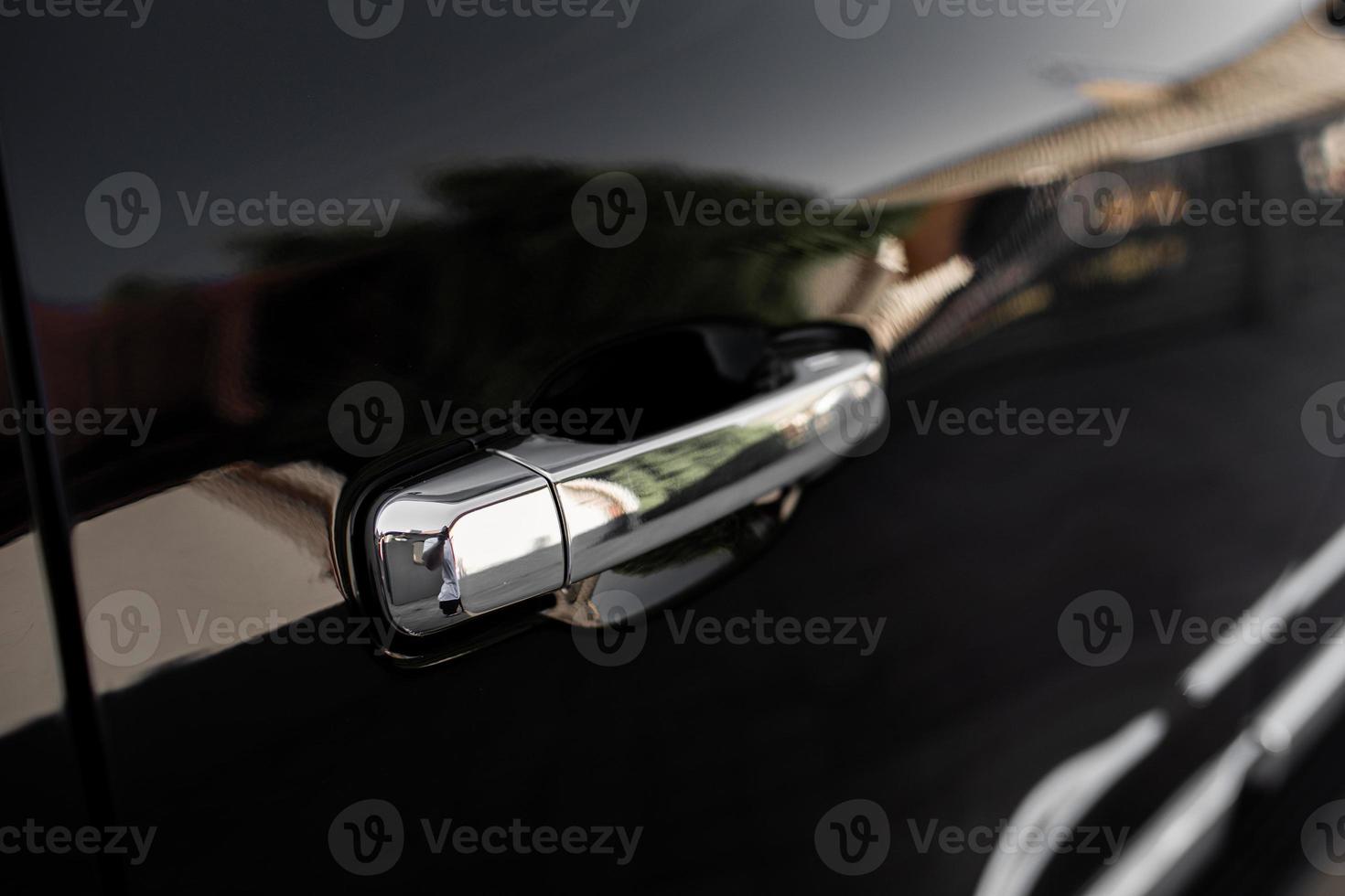 Car door handle on driver's door of modern black car. High quality photo