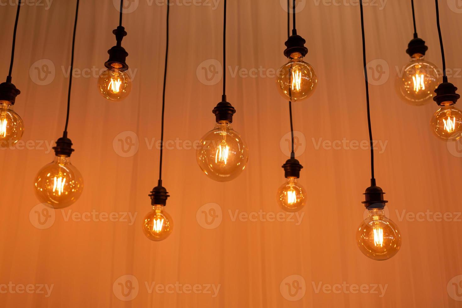 Edison light bulb background. Vintage lamps over concrete background. selective focus photo