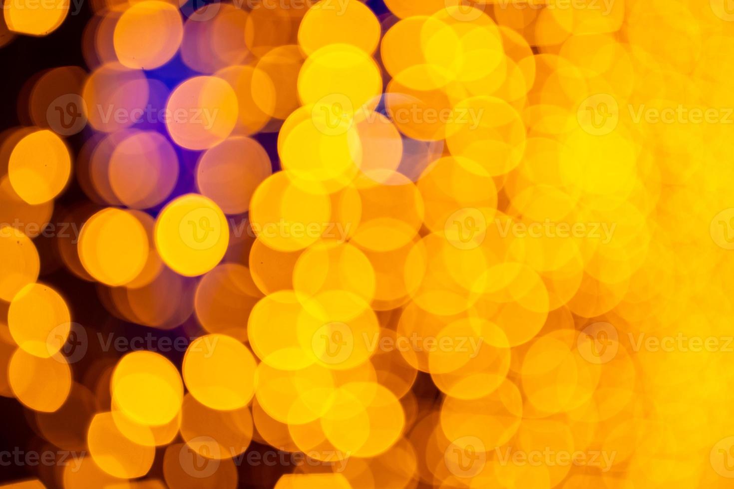 Bokeh de fondo circular abstracto de luz navideña. bokeh de guirnaldas. fondo para salvapantallas. luces desenfocadas. Bokeh borroso con luces de color amarillo. foto