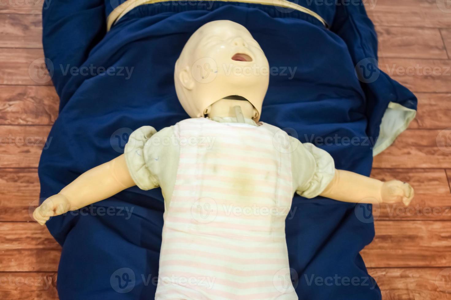 Man performing CPR on baby training doll dummy with one hand compression. First Aid Training - Cardiopulmonary resuscitation. First aid course on CPR dummy, CPR First Aid Training Concept photo