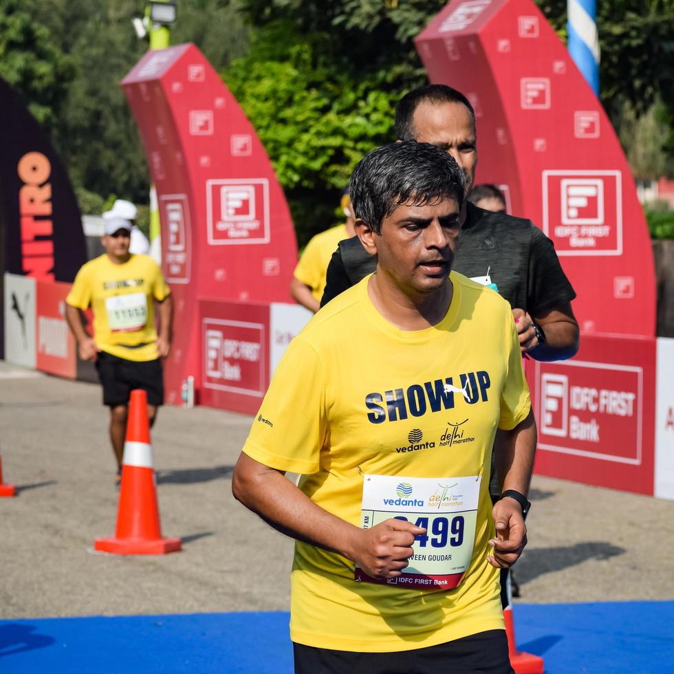 New Delhi, India - October 16 2022 - Vedanta Delhi Half Marathon race after covid in which marathon participants about to cross the finish line, Delhi Half Marathon 2022 photo