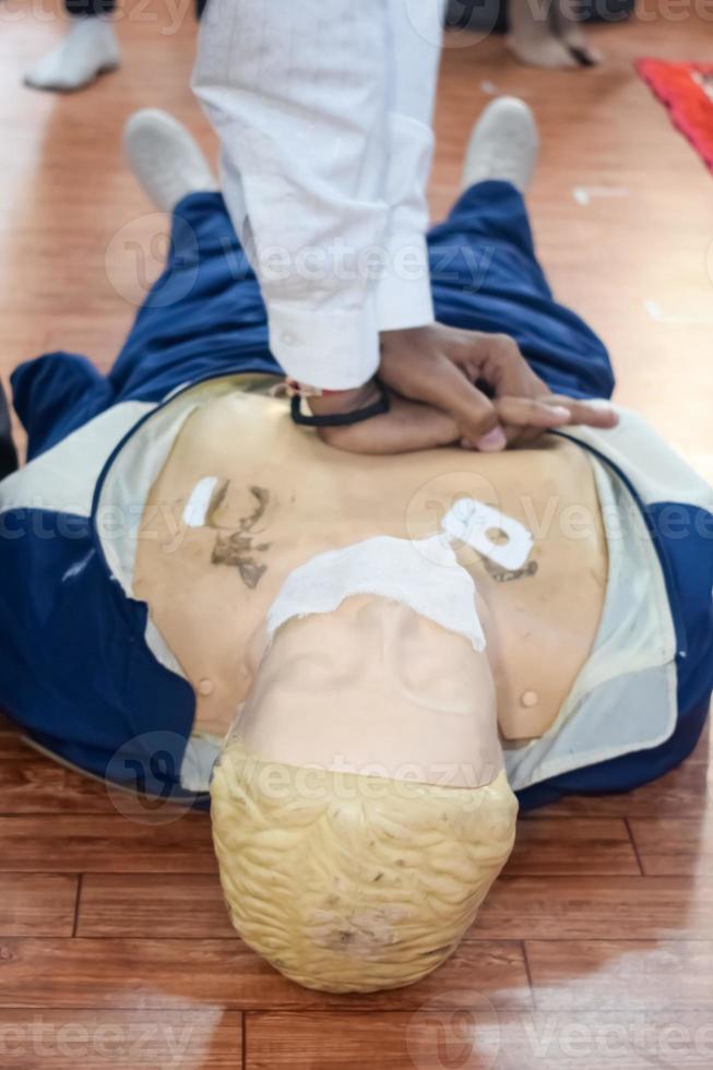 Human dummy lies on the floor during first Aid Training - Cardiopulmonary resuscitation. First aid course on CPR dummy, CPR First Aid Training Concept photo