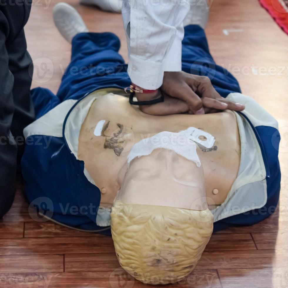 Human dummy lies on the floor during first Aid Training - Cardiopulmonary resuscitation. First aid course on CPR dummy, CPR First Aid Training Concept photo