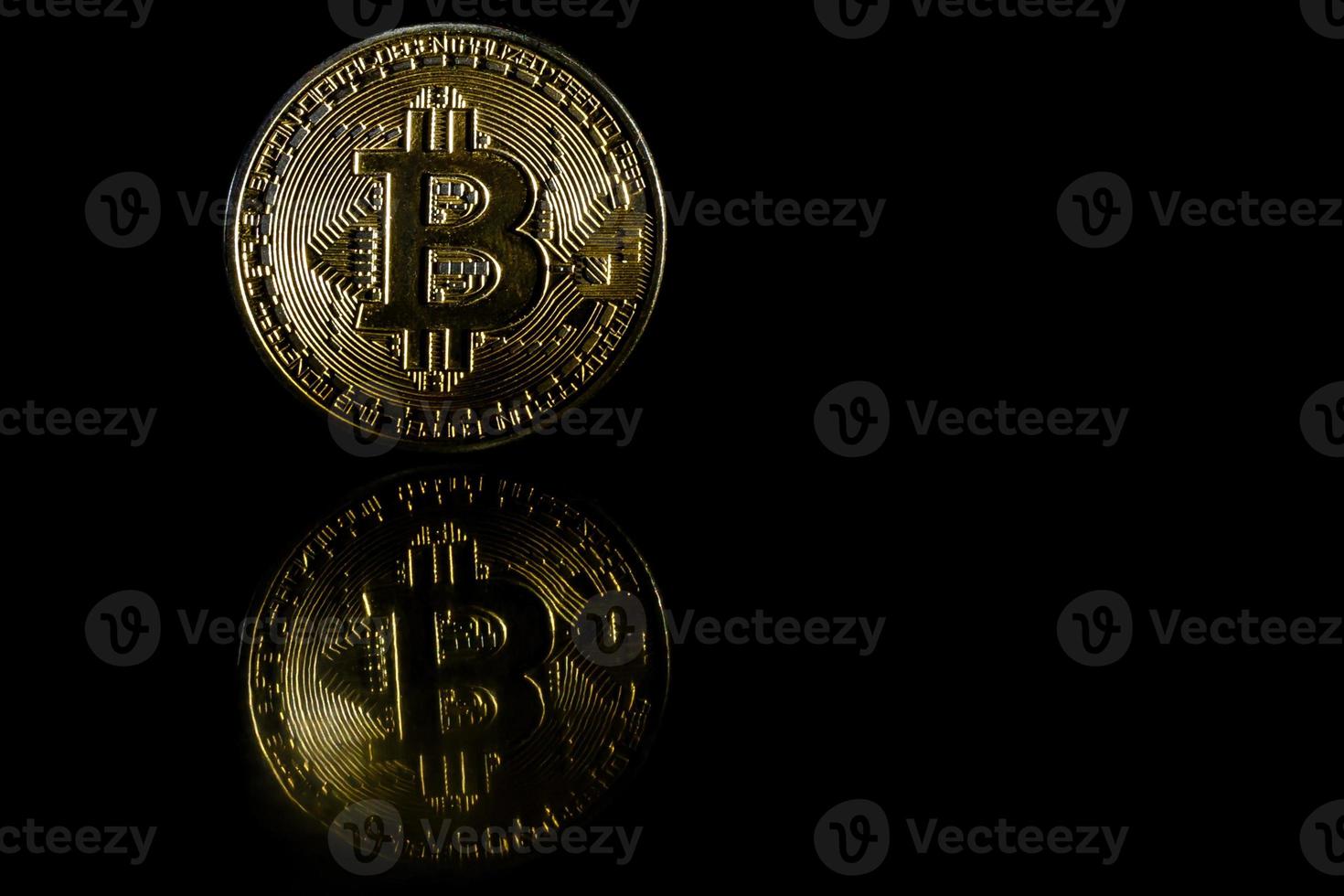 Golden bitcoin on black background with copy space cryptocurrency mining concept photo